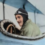 man inside biplane