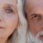 A detailed close-up image showing the half faces of an elderly couple with gray hair.