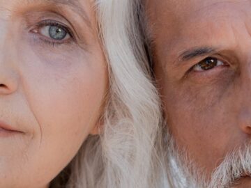 A detailed close-up image showing the half faces of an elderly couple with gray hair.