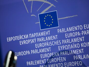 Close-up view of the European Union flag with multilingual text showing European Parliament.