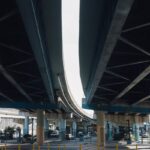 View of a modern urban overpass with vehicles and traffic below, captured in daylight.