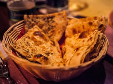 Close-up of traditional Indian flatbreads in a basket, perfect for a delicious meal.