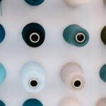 Top-down view of colorful threads neatly arranged on a white background, showcasing vibrant shades.