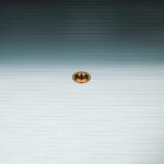 A minimalist Batman logo on a metallic roll-up door in daylight, Shilin District, Taipei.