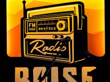 Retro radio sign with microphones and drums at a Boise music venue, highlighting local vibes.