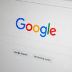 Close-up of the Google homepage on a screen showing search options.