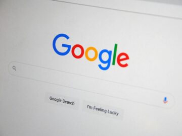 Close-up of the Google homepage on a screen showing search options.