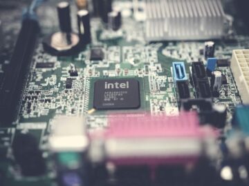 Detailed image of a computer motherboard highlighting an Intel chip with surrounding components.