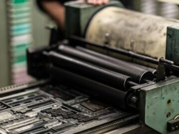 Detailed view of an industrial printing press with precise mechanics.