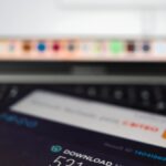 Close-up of a smartphone showing internet speed test results with a laptop in the background.