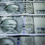 Close-up of Indian 500 rupee banknotes featuring Gandhi's portrait. Selective focus.