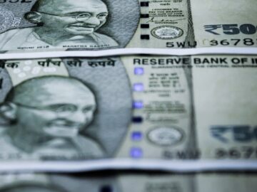 Close-up of Indian 500 rupee banknotes featuring Gandhi's portrait. Selective focus.
