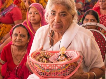 Devotees in Rishikesh celebrating a Hindu religious ceremony with traditional attire.