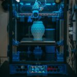 Close-up of a 3D printer in action, crafting a detailed vase in a modern setting.