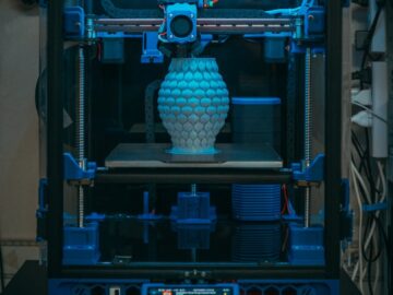 Close-up of a 3D printer in action, crafting a detailed vase in a modern setting.
