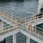 Aerial view of industrial pier with railings above water in Delta, BC, Canada.