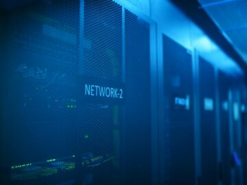 A modern server room featuring network equipment with blue illumination. Ideal for technology themes.