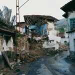 A devastated urban street in Malatya, Turkey after an earthquake, showcasing collapsed traditional houses.