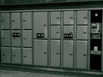 Secure metal lockers with electronic payment system at a station.