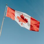 A Canadian flag waving gracefully against a clear blue sky in Dartmouth, NS.