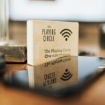 A wooden block displaying Wi-Fi details sits on a modern office desk.