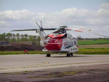 HM Coastguard helicopter on runway in Kingston upon Hull, ready for rescue operations.