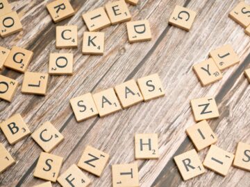Wooden letter tiles spelling SaaS on rustic wood. Ideal for cloud computing and business concepts.