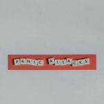 a red piece of paper with the words panic attacks spelled on it