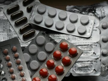 Close-up of various pills in blister packs showcasing medical and healthcare themes.