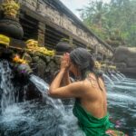 Women participating in a sacred water purification ritual at Pura Tirta Empul Temple in Bali, Indonesia.