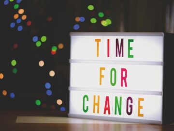 Colorful illuminated sign displaying the motivational message 'Time for Change'.