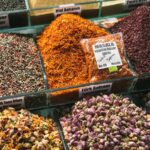 Vibrant assortment of spices and herbs at a market stall, showcasing diversity and culture.