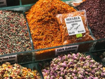 Vibrant assortment of spices and herbs at a market stall, showcasing diversity and culture.