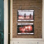 Interior of a rustic urban wall featuring thought-provoking fire posters.