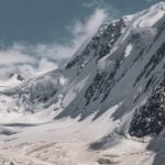 Serene winter landscape of snowcapped mountains in Zermatt, showcasing winter's pristine beauty.