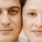 A close-up portrait of a smiling couple showcasing their facial expressions and features.
