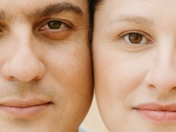 A close-up portrait of a smiling couple showcasing their facial expressions and features.