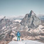 A mountaineer stands facing the iconic Matterhorn in Zermatt, Switzerland for an adventurous climb.