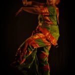 Elegant Indian classical dancer in a vibrant traditional costume performing a pose. Captured in Kolkata, India.