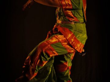 Elegant Indian classical dancer in a vibrant traditional costume performing a pose. Captured in Kolkata, India.