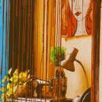 Retro styled sewing corner with vintage machine and artistic decor, perfect for creative designs.