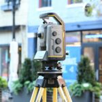 Sophisticated surveying equipment on city street showcasing modern urban mapping technology.