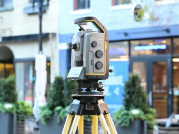 Sophisticated surveying equipment on city street showcasing modern urban mapping technology.