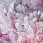 A detailed close-up of rose quartz crystals showcasing their pink hues and translucent nature.