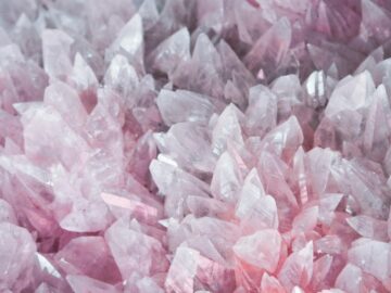 A detailed close-up of rose quartz crystals showcasing their pink hues and translucent nature.