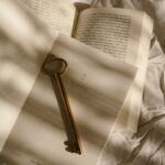 Aesthetic shot of a vintage key on an open notebook, casting soft shadows.