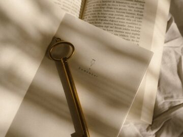 Aesthetic shot of a vintage key on an open notebook, casting soft shadows.