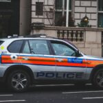 Police vehicle parked on an urban street outside a London building