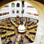 A stunning aerial view of a grand library with people studying at tables.
