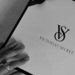 Monochrome image of a Victoria's Secret gift box with ribbon detail.